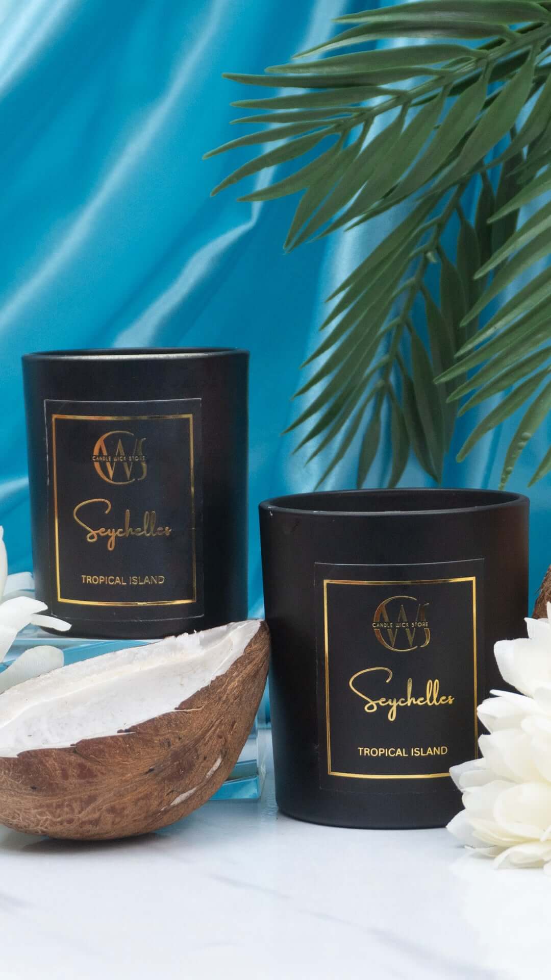 Seychelles scented candles with tropical island scent, featuring elegant black packaging and natural elements.
